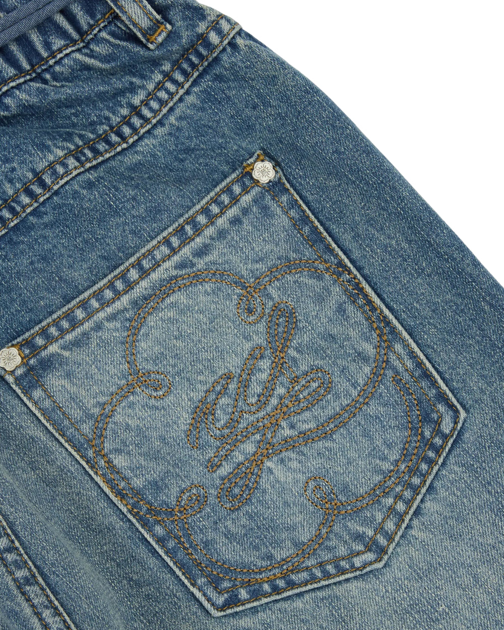 Close-up of the pocket on the MEDIUM BLUE FRESHMAN FIT DENIM by Sundae School, featuring decorative brown stitching in a floral and cursive pattern. The pocket is accented with rivets at the corners and distinct seam details, adding a unique touch inspired by hanbok denim. These thoughtful elements elevate the boyfriend fit silhouette with a subtle nod to traditional style.