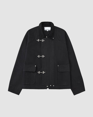 The [PRE-ORDER] BLACK FIREMAN CLASP JACKET by Sundae School is a vintage-style black cotton jacket with silver toggle clasps, two front flap pockets, collar, and visible seam details, shown on a plain light gray background.
