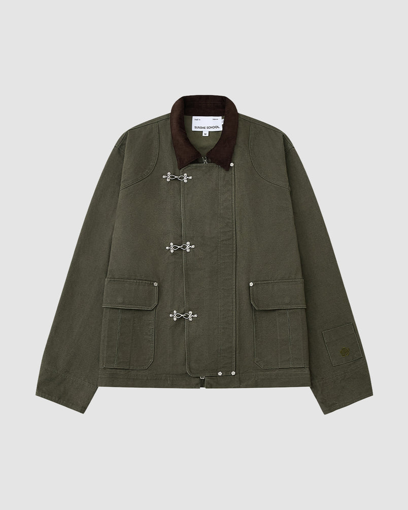The [PRE-ORDER] OLIVE FIREMAN CLASP JACKET by Sundae School features vintage olive cotton, a dark brown collar, silver clasp closures, two large front pockets, and visible stitching, showcased on a plain light gray background.