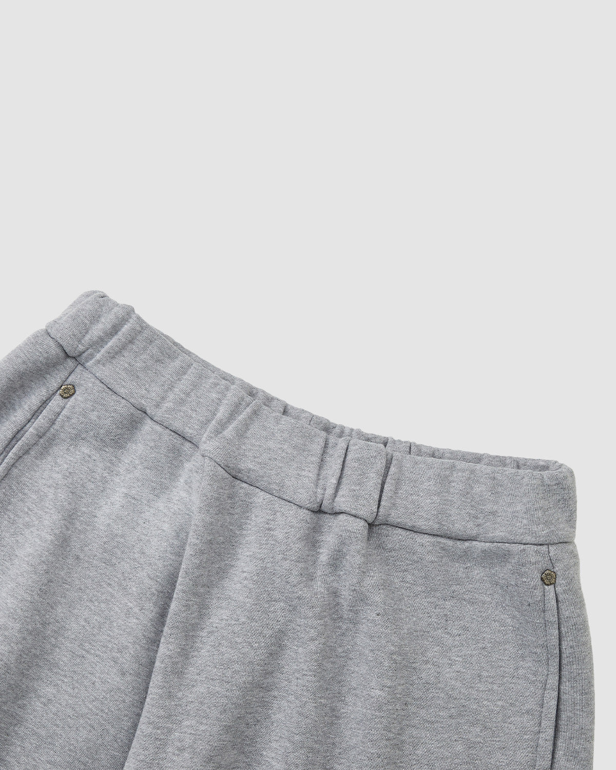HEATHER GREY WRAP SWEATBAJI by Sundae School—unisex cotton pants in heather grey, featuring an elastic waistband and side pockets, displayed waist-down against a plain light background.