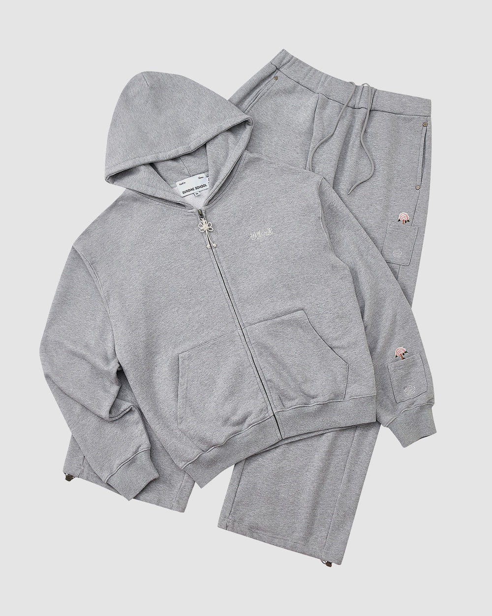 The Sundae School HEATHER GREY WRAP SWEATBAJI is a heather gray tracksuit set with a zip-up hoodie and Hanbok-inspired wide leg sweatpants, featuring small embroidered details, shown against a plain white background.