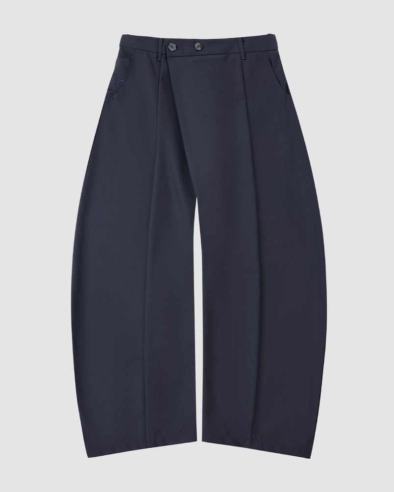 NAVY PLEATED HANBOK SLACKS by Sundae School: high-waisted wide-leg pants in navy wool blend, featuring front pleats, side pockets, and two buttons at the waistband, displayed flat on a white background.