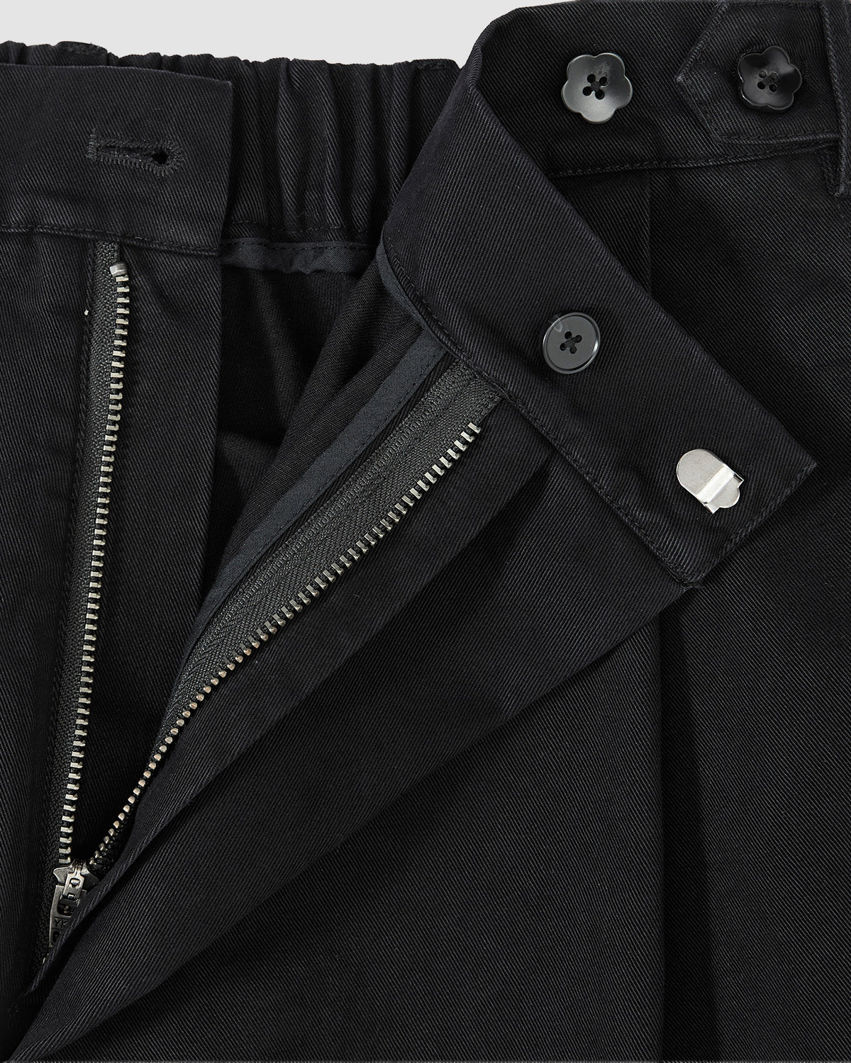 Close-up of Sundae School BLACK HANBOK CHINO PANTS with zipper, button, and clasp open, highlighting the waistband and stitching. These unisex chinos feature a subtle hanbok-inspired silhouette.