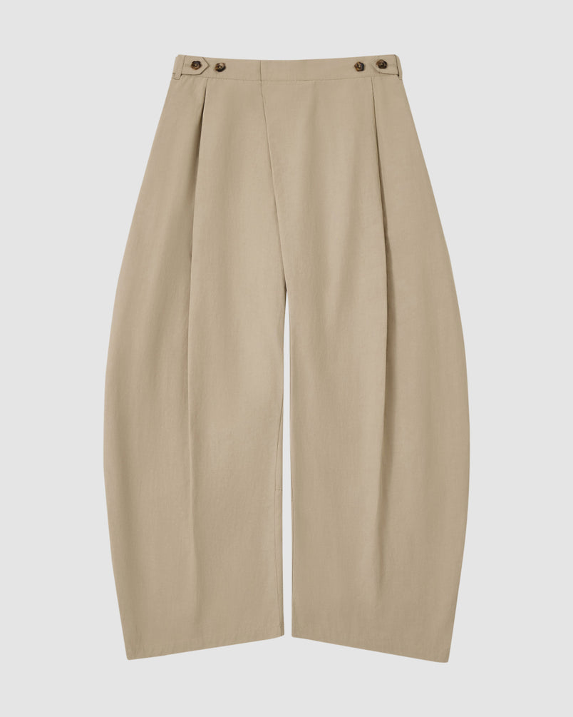 The Sundae School WHEAT HANBOK LINEN PANTS feature a beige cotton-linen blend, high waist, front pleats, wide barrel leg, and adjustable buttoned waistband, shown flat on a white background.