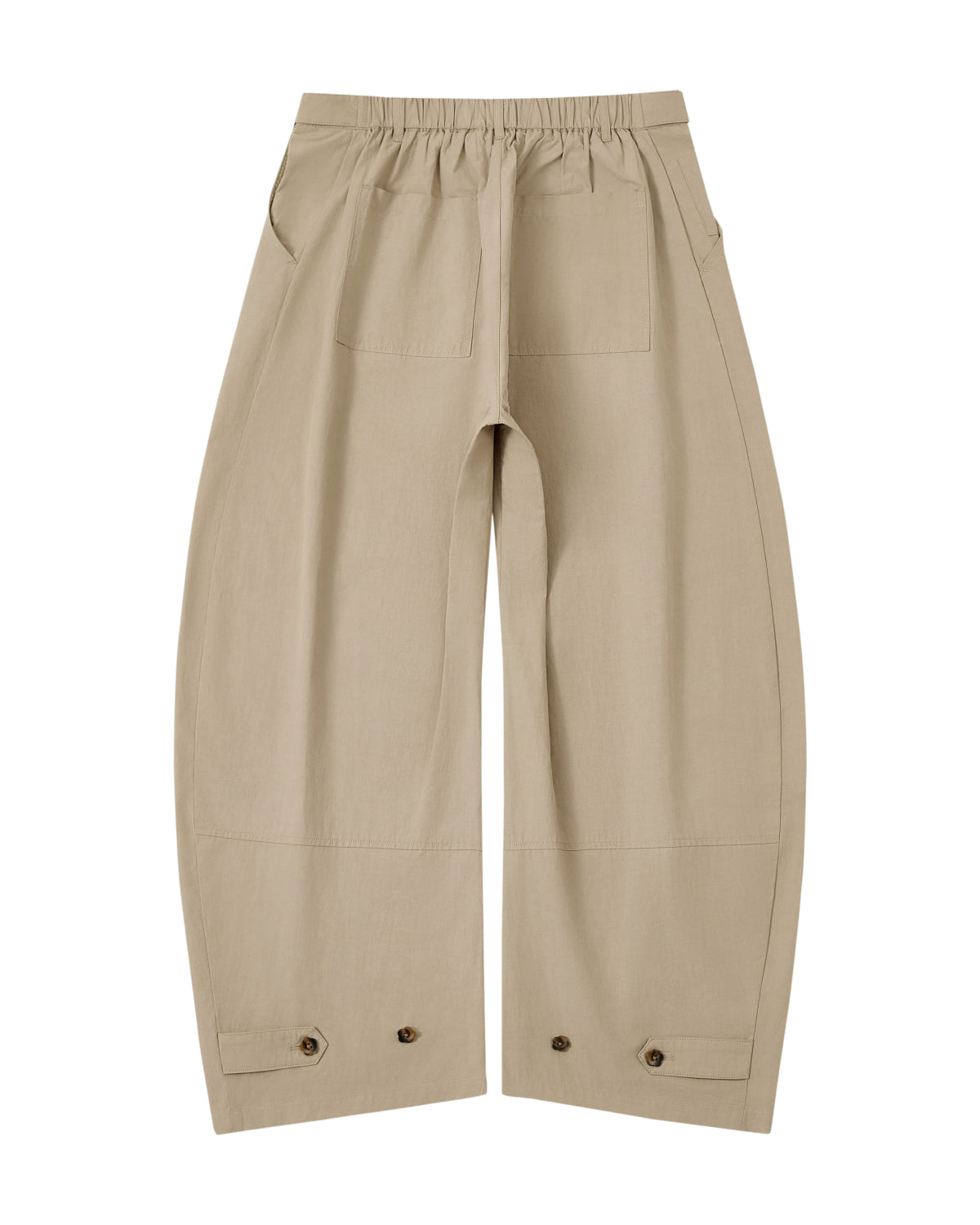 The WHEAT HANBOK LINEN PANTS by Sundae School are beige cotton-linen balloon pants with a wide barrel leg silhouette, an elastic waistband for adjustable fit, two front patch pockets, and button details near the hem, shown laid flat on a white background.