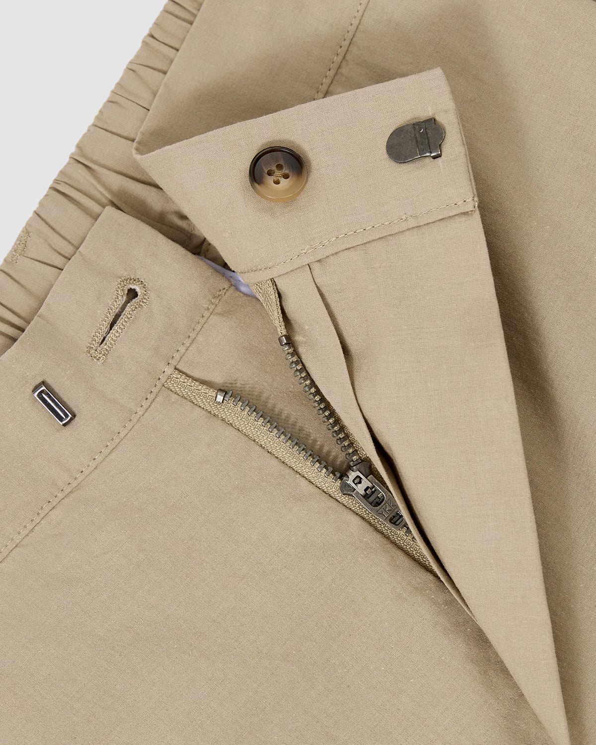 Close-up of Sundae School's WHEAT HANBOK LINEN PANTS, showing wide barrel legs, open zipper fly, button and metal hook closure, plus a partially visible adjustable elastic waistband.