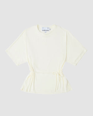 The IVORY BAERAE T-SHIRT by Sundae School, inspired by the traditional Korean durumagi, features short sleeves, a round neck, drawstring waist, and an off-white hue. It is laid flat on a light gray background with a white label at the neckline.