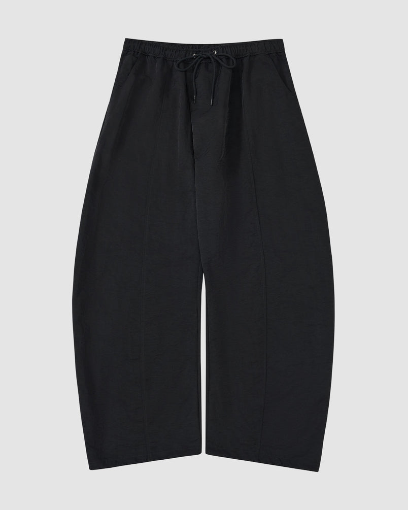 The BLACK HANBOK BALLOON TRACK PANTS by Sundae School feature a wide-leg fit, drawstring waist, vertical seams, and technical nylon fabric for windproof and water-resistant performance.