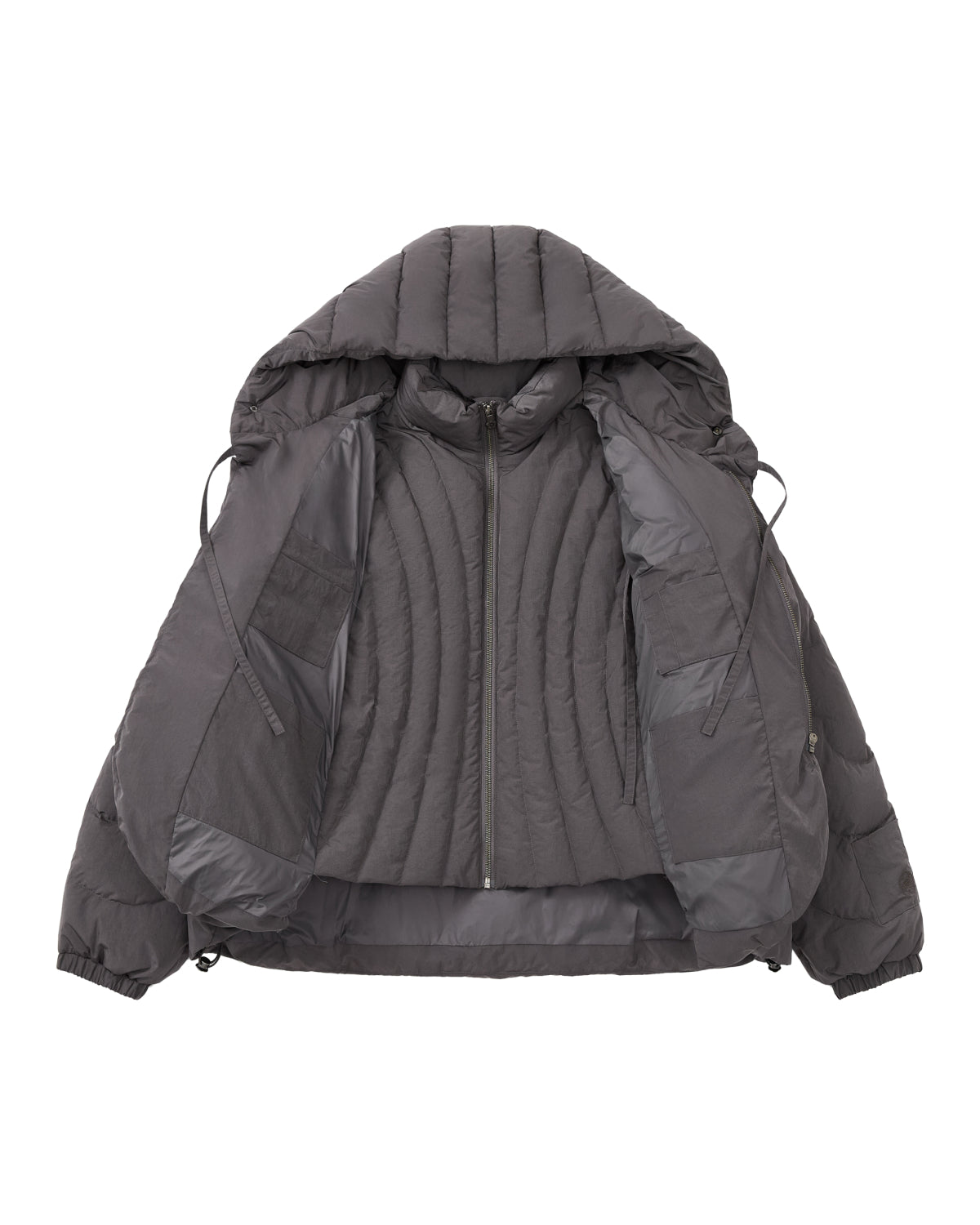 The CHARCOAL HEAVYWEIGHT MOCHI PUFFER by Sundae School is a dark gray puffer jacket featuring a hood, zippered front, and a quilted duck down-filled interior, shown open and laid flat on a white background.
