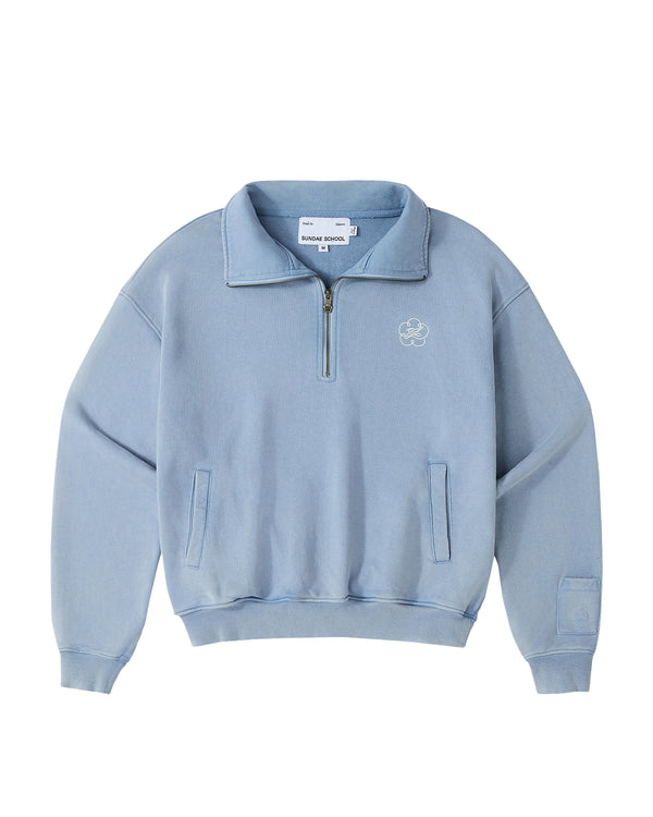 Introducing the SKY BLUE HESTER QUARTER ZIP by Sundae School—a light blue, long-sleeve oversized pullover featuring a quarter zip, funnel neck collar, and front chest logo. Designed with two side pockets, ribbed cuffs and hem, and a visible Sundae School label inside the collar, this vintage cotton piece seamlessly combines comfort with classic style for an effortlessly timeless look.