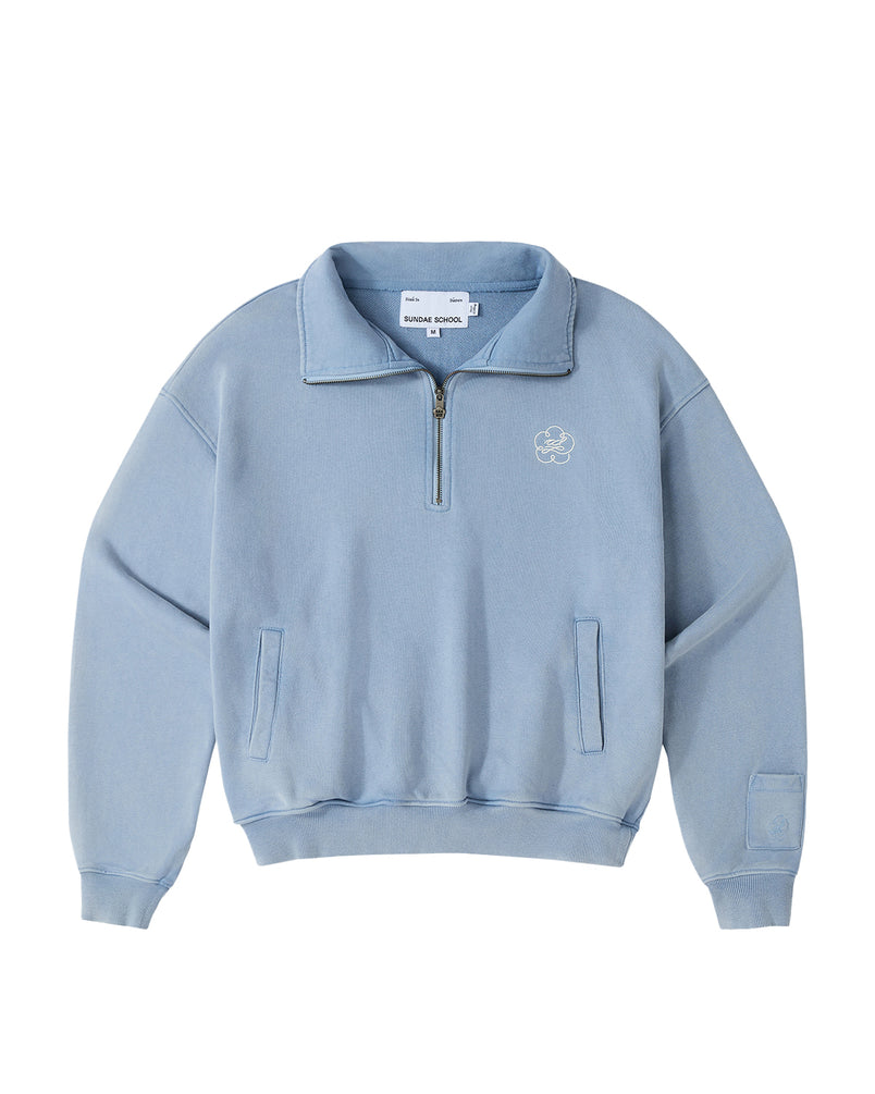 Introducing the SKY BLUE HESTER QUARTER ZIP by Sundae School—a light blue, long-sleeve oversized pullover featuring a quarter zip, funnel neck collar, and front chest logo. Designed with two side pockets, ribbed cuffs and hem, and a visible Sundae School label inside the collar, this vintage cotton piece seamlessly combines comfort with classic style for an effortlessly timeless look.
