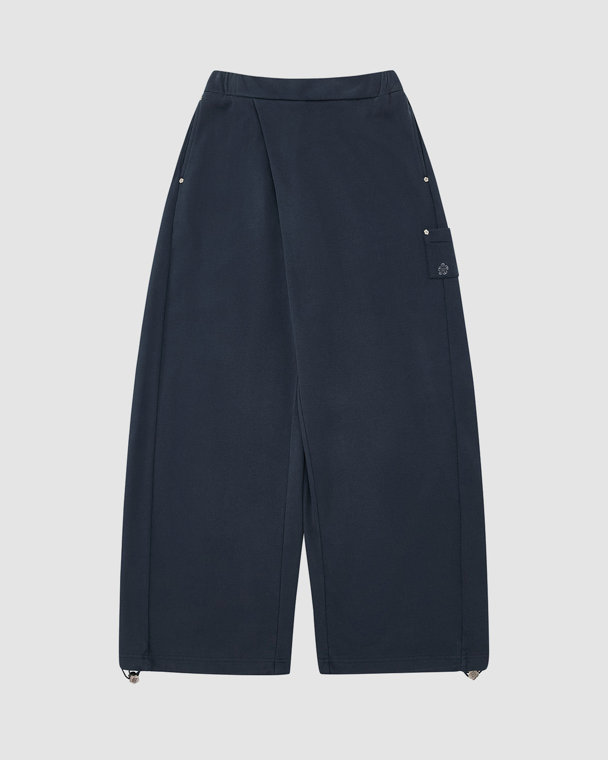 The Sundae School INDIGO WASH WRAP SWEATBAJI features navy blue, Hanbok-inspired wide legs, a high waist, snap buttons at the hips, a side flap pocket, and adjustable drawstring hems on a plain light background.