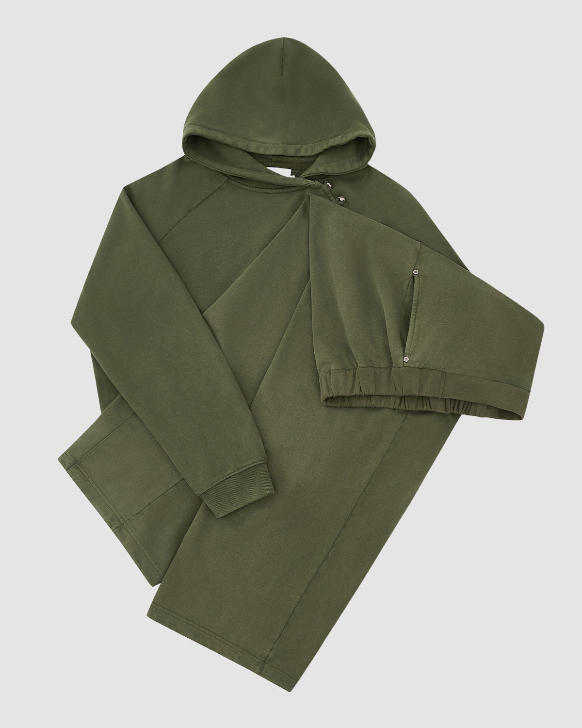 The KHAKI HANBOK HOODIE by Sundae School, in olive green, is displayed flat on a white background with one sleeve crossed to show the elastic cuff and signature stash pocket, featuring a classic kangaroo pocket.