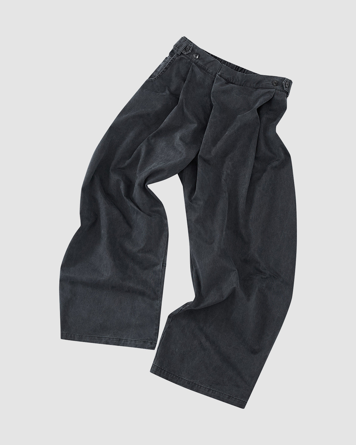 Sundae School’s CHARCOAL HANBOK CHINO PANTS feature a hanbok-inspired, loose wide-leg silhouette with waist pleats, side pockets, and button details, shown laid flat on a light gray background.