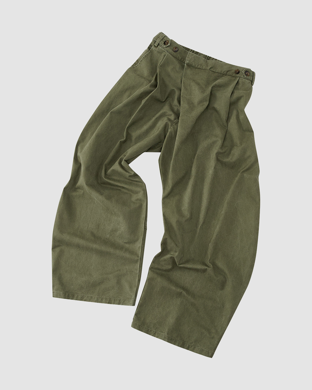 Sundae School's OLIVE HANBOK CHINO PANTS feature a loose fit, pleats, high waist, and buttoned waistband for a hanbok-inspired silhouette, displayed flat against a light background.