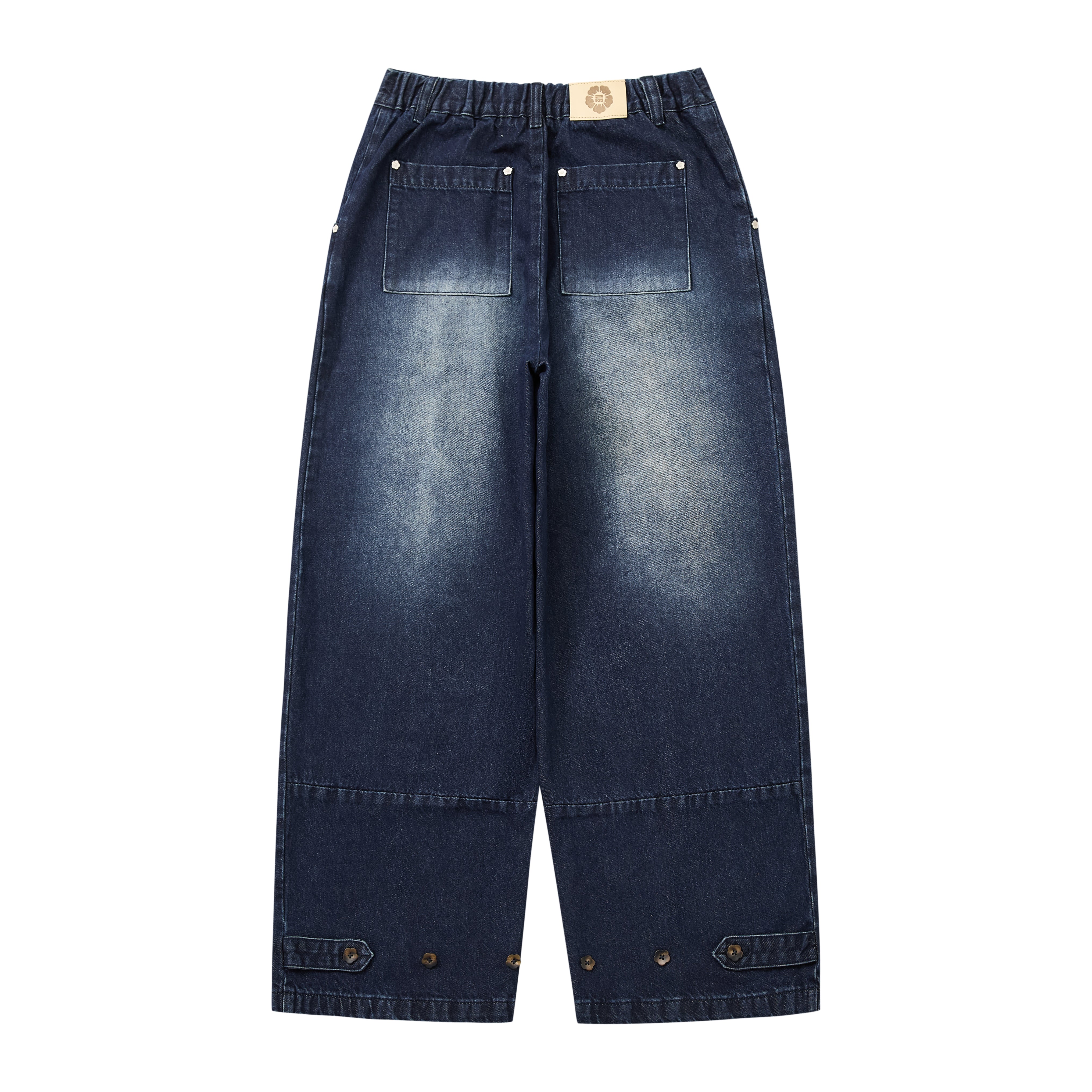 A pair of dark blue denim cropped pants with a high elastic waistband, front patch pockets, and buttoned flap details at the cuffs, shown against a plain white background.