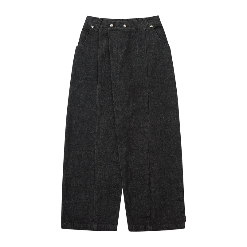 A pair of wide-leg cropped pants in a dark charcoal gray denim-like fabric, featuring a wrap-style front closure with silver metal snaps, side pockets, and a relaxed straight-leg silhouette.