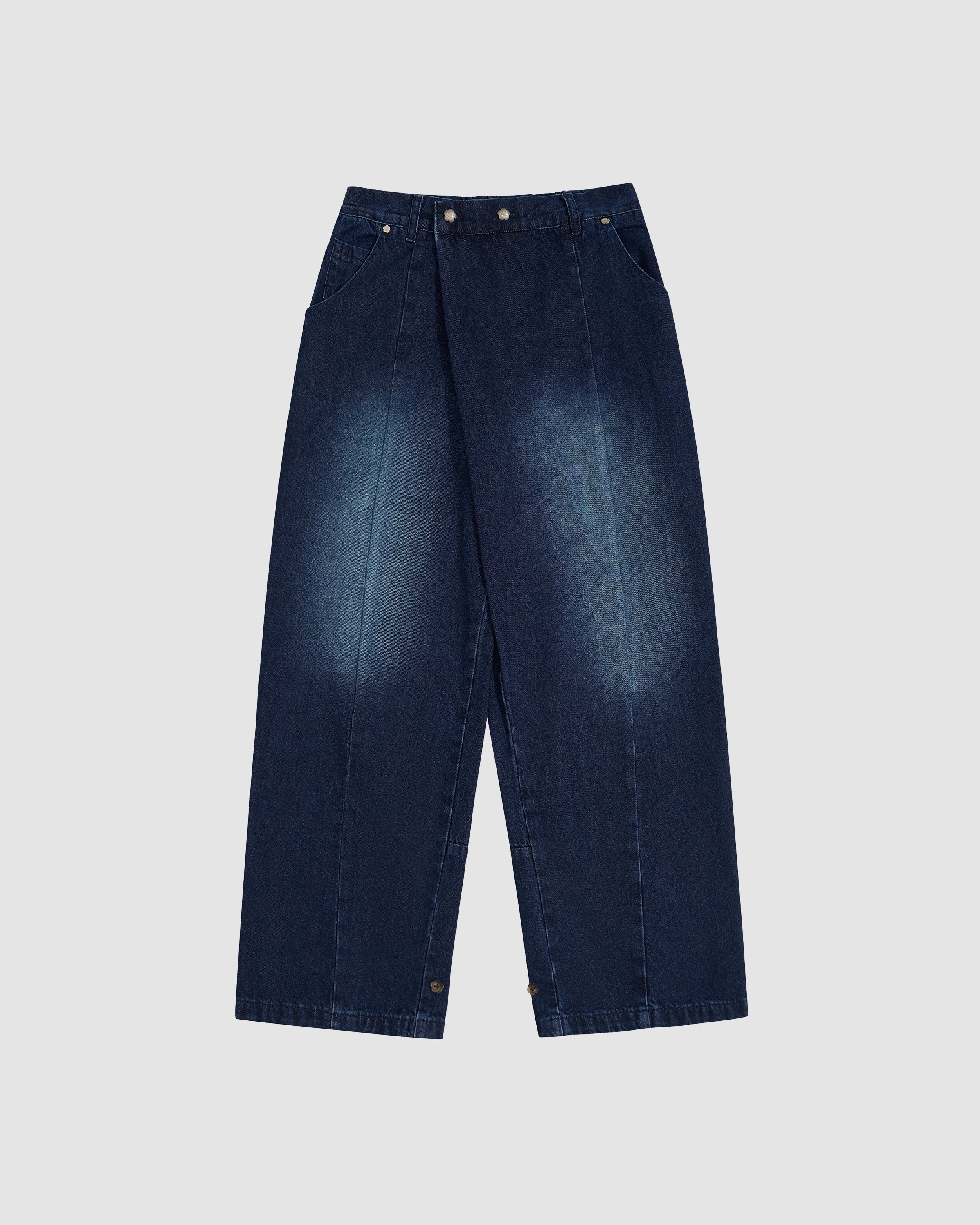 Indigo fade wide-leg hanbok denim pants with high-rise waist and asymmetric front closure featuring silver flower-shaped snap buttons, relaxed fit silhouette, flat lay photography on light gray background