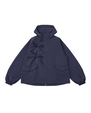 The Sundae School NAVY JEOGORI TIE SHELL JACKET features a water-resistant navy shell, two front pockets, elastic cuffs, and dual bow tie closures, shown against a plain light gray background.