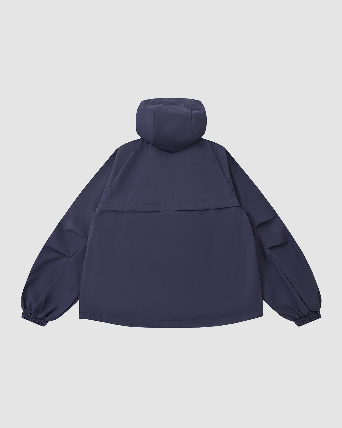 The NAVY JEOGORI TIE SHELL JACKET by Sundae School is a unisex technical outerwear piece in navy blue, featuring a water-resistant shell, elastic cuffs, long sleeves, and a relaxed fit. Shown from the back against a plain light background.