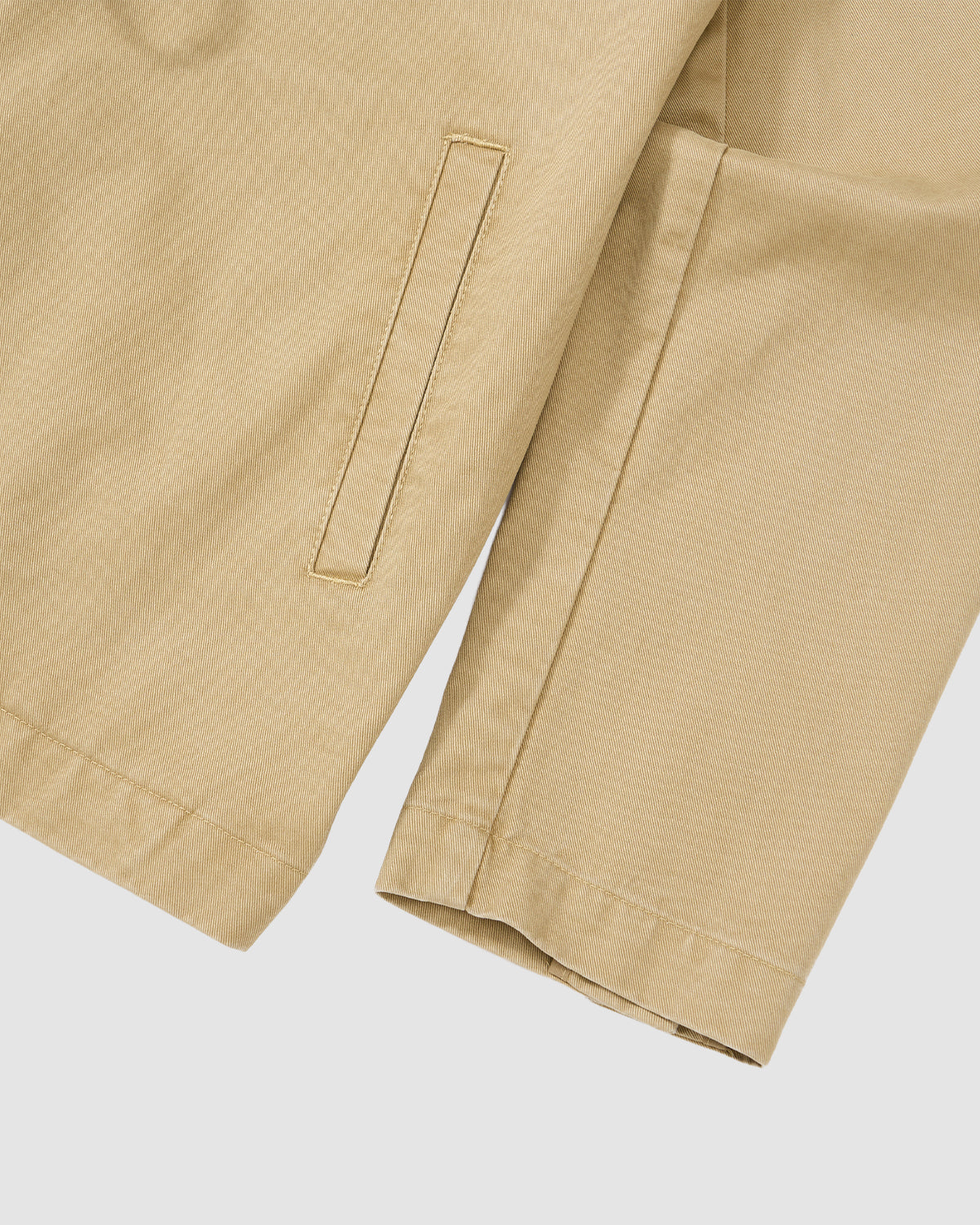 Close-up of the Sundae School TAN JEOGORI TIE JACKET, highlighting its beige sleeve and straight welt pocket on smooth fabric, with summer suiting details, set against a plain white background.