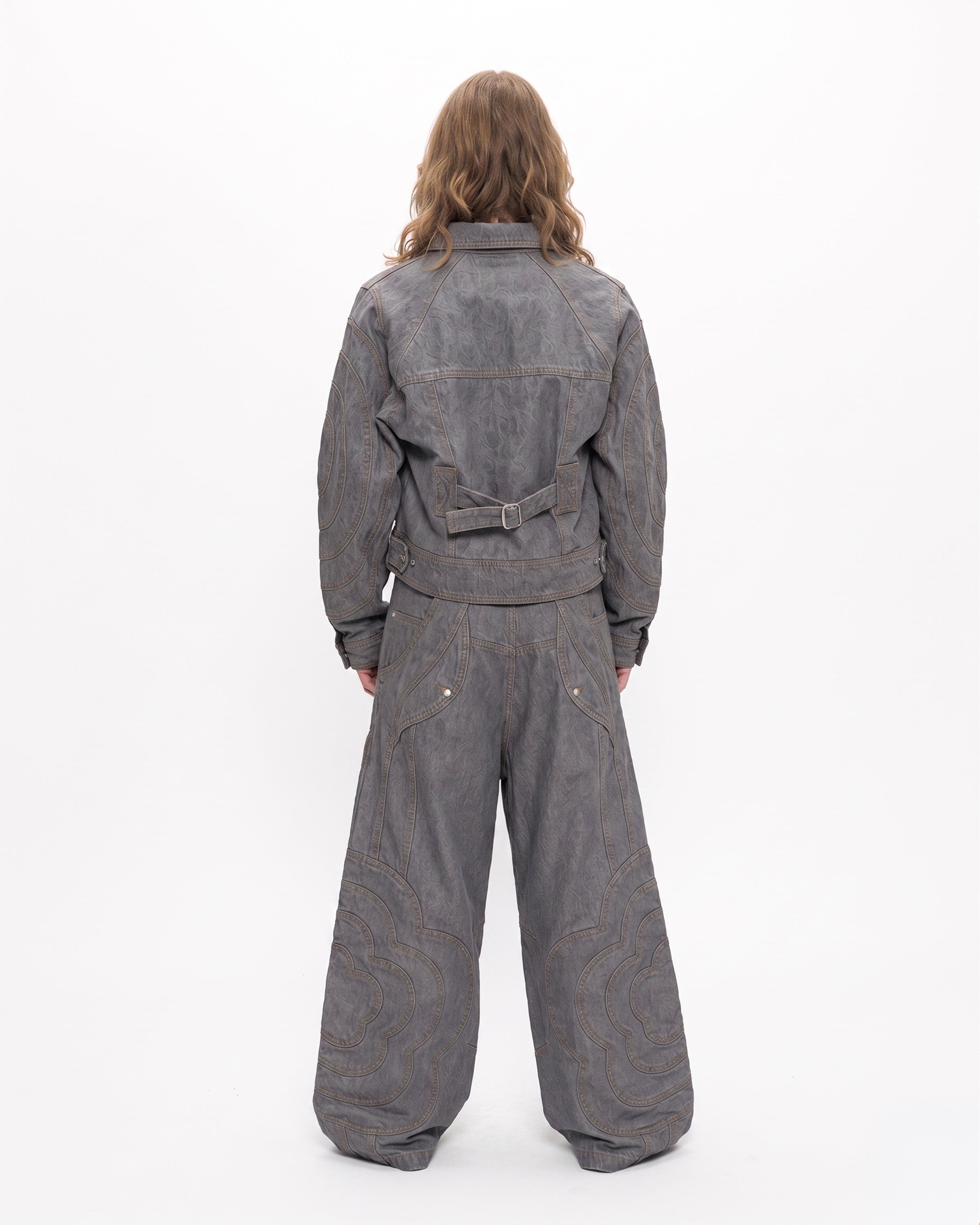 A person with long brown hair wears Sundae School's JOONIVERSE JEANS GREY and a grey denim jacket, standing against a plain white background.