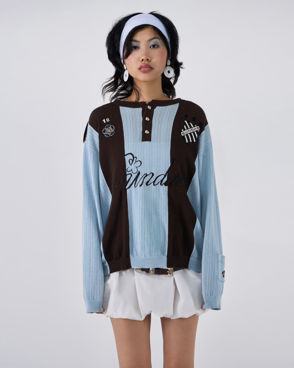 Baby Blue Brown Sundae Soccer Jersey Knit modeled on Asian female model wearing white headband and white earrings, featuring light blue and brown vertical stripes, henley button placket, 