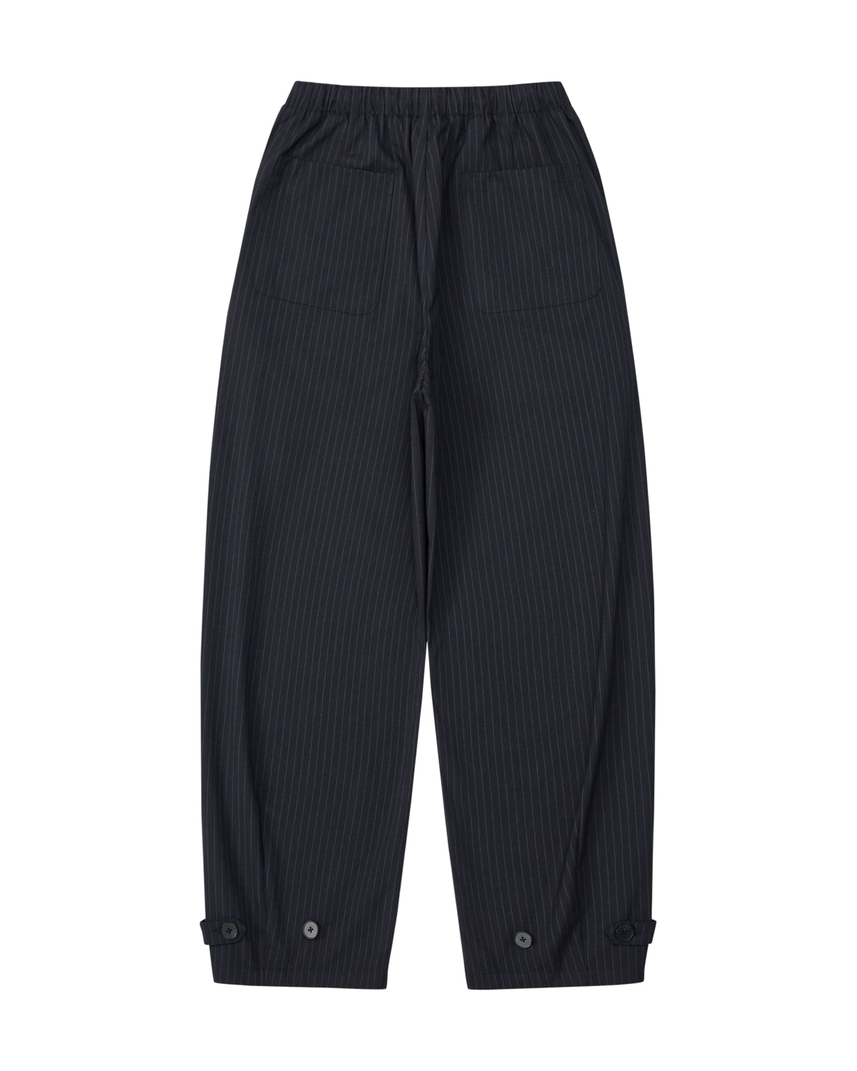 The KIKI DRAWSTRING SLACKS by Sundae School are black pinstripe sweatpants with an elastic drawstring waist, two large front pockets, and buttoned cuffs at the ankles. Laid flat on a white background, their relaxed barrel leg silhouette lends a modern edge to this versatile style.