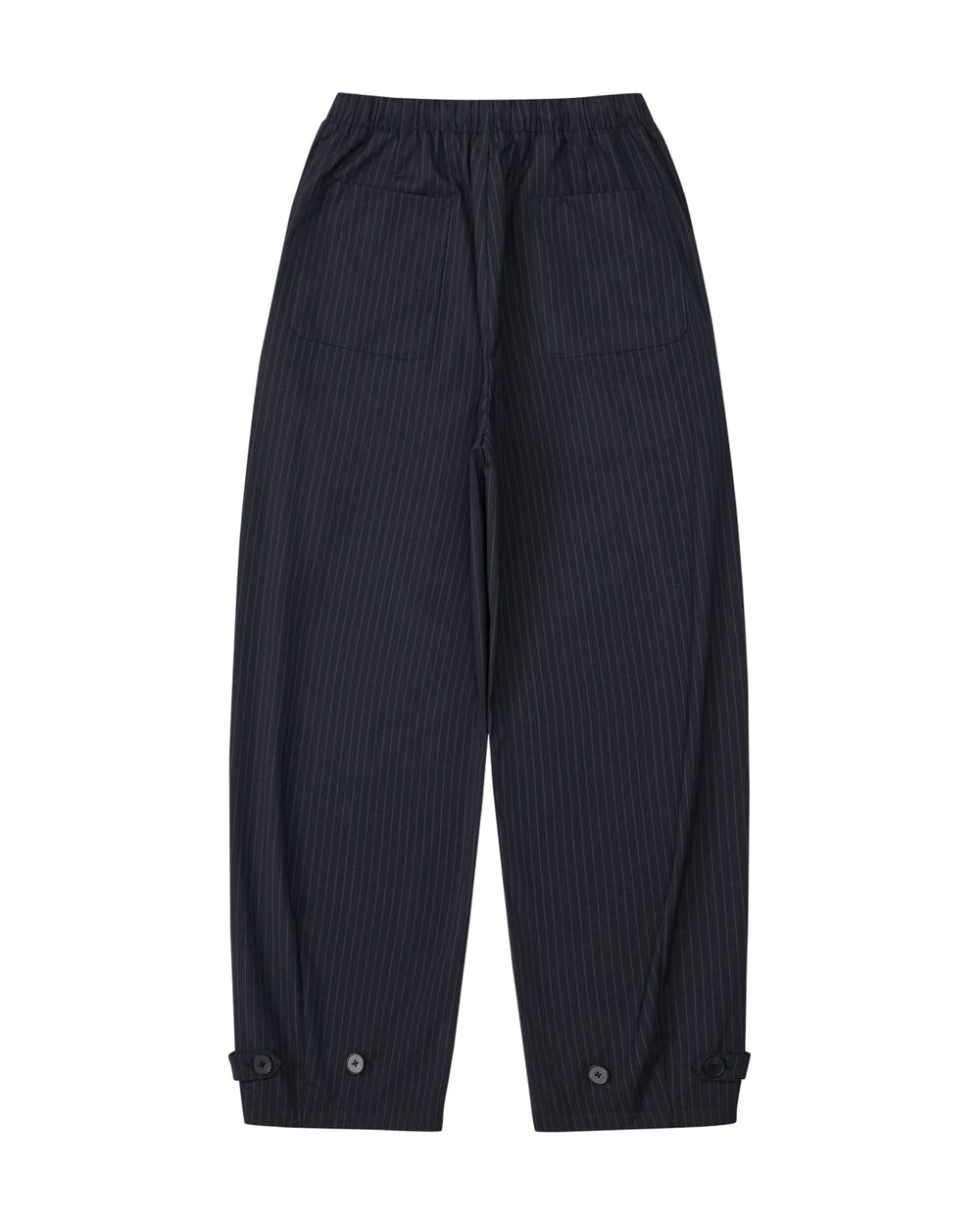 The KIKI DRAWSTRING SLACKS by Sundae School are black pinstripe sweatpants with an elastic drawstring waist, two large front pockets, and buttoned cuffs at the ankles. Laid flat on a white background, their relaxed barrel leg silhouette lends a modern edge to this versatile style.