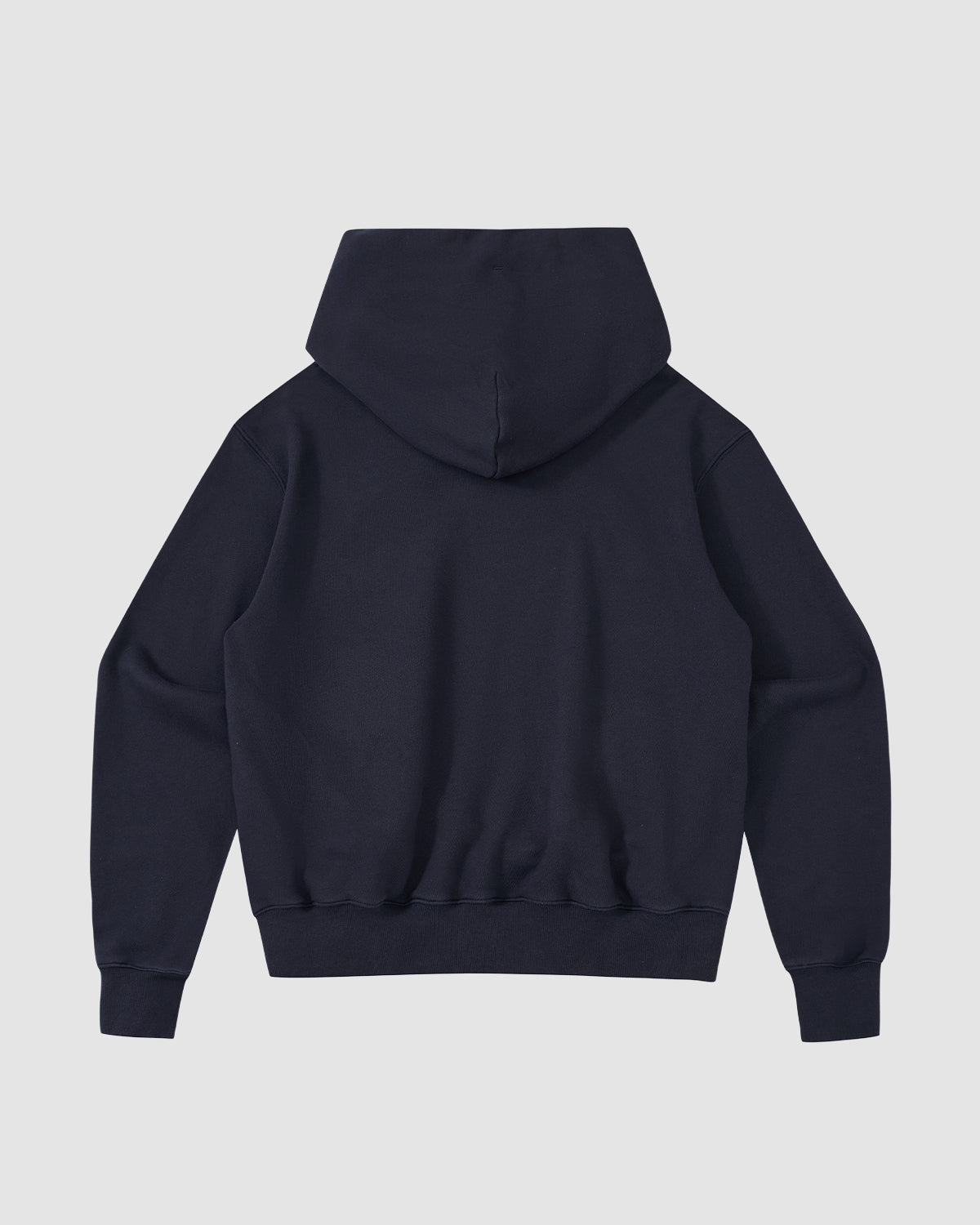 The Sundae School NAVY KNIT TIE HOODIE is shown from the back against a light gray background. This heavyweight hoodie has long sleeves, a fitted waistband, and no visible logos or designs.