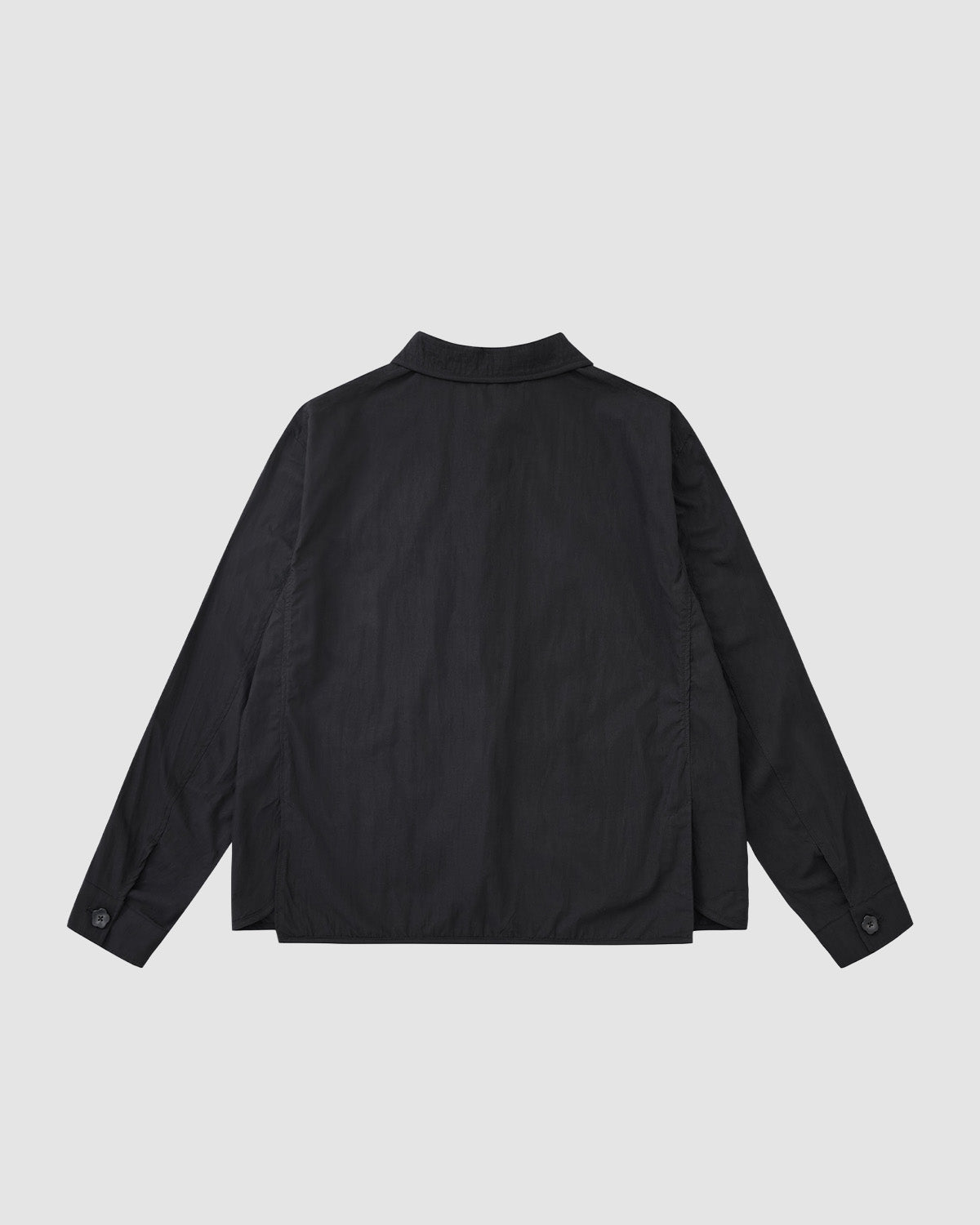 Back view of the Sundae School KNOT TIE TOWN JACKET, a unisex quilted black jacket with collar, buttoned cuffs, and straight hem, shown on a light gray background—perfect for spring uniforms.