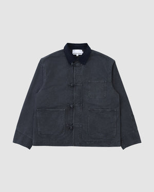 The CHARCOAL KNOT BARN JACKET by Sundae School is a dark gray enzyme-washed waxed chino chore coat with a black collar, three front toggle closures, and three large front pockets, shown flat on a light gray background.