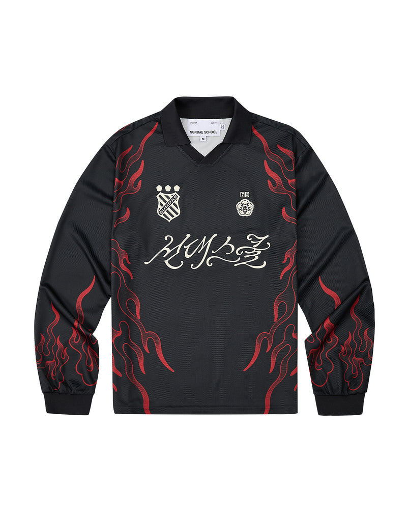 Sundae School’s KOREATOWN FOOTBALL JERSEY features black long sleeves accented with red flame designs along the sleeves and sides, white logos and badges on the chest, and bold stylized calligraphy across the front—a striking piece inspired by K-Town fashion, perfect for fans of custom lettered apparel.