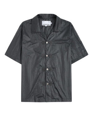 The MAEHWA EMBROIDERED SHEER SHIRT by Sundae School is a short-sleeve, dark gray, collared button-up featuring a crinkled texture and distinctive flower-shaped black buttons down the front—this unisex going-out shirt effortlessly elevates any look with its unique edge.