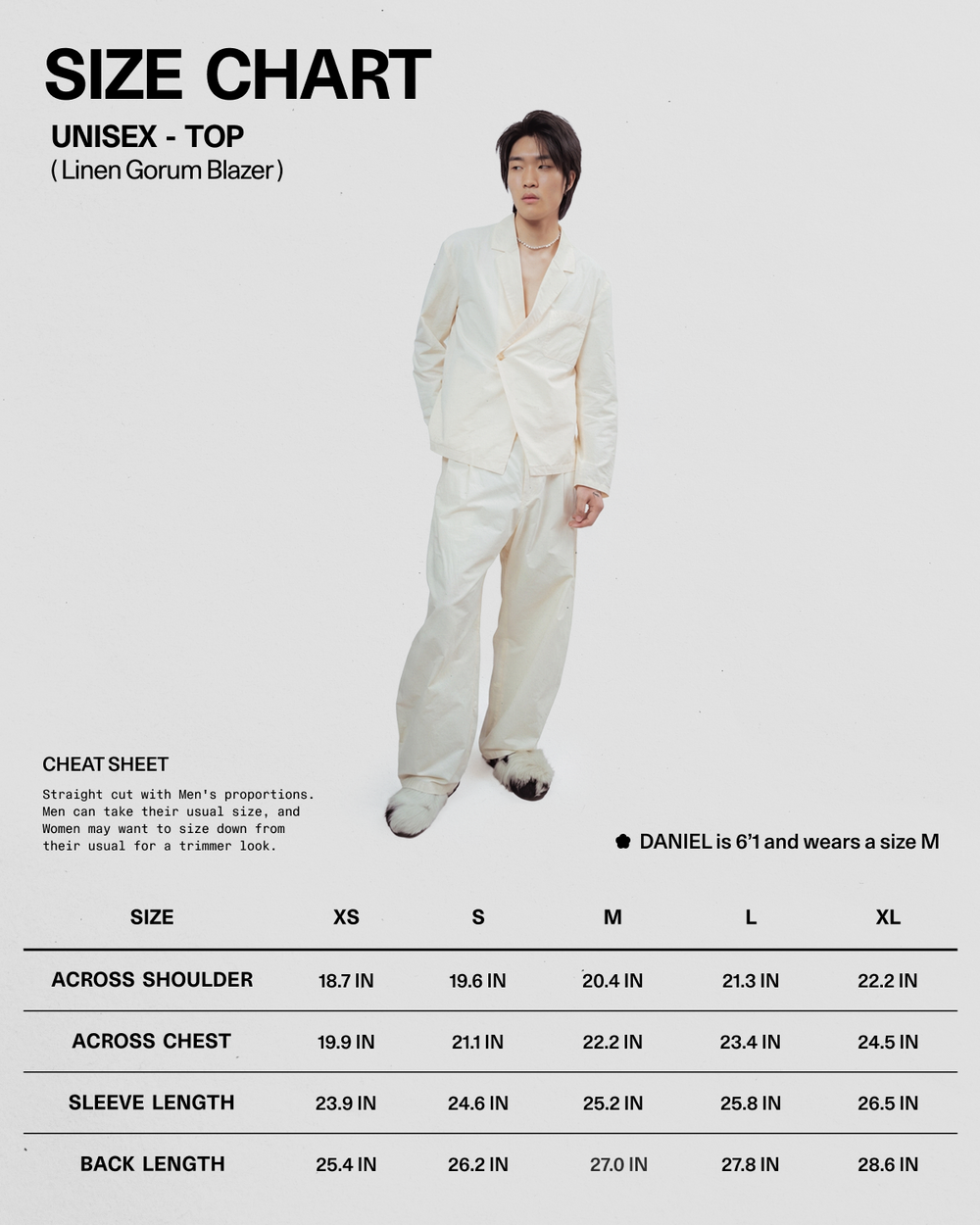 A person wearing the IVORY LINEN GORUM BLAZER and matching pants from Sundae School stands next to a size chart for this unisex linen blazer, which displays measurements for sizes XS to XL and notes that Daniel is 6'1" and wears a size M.