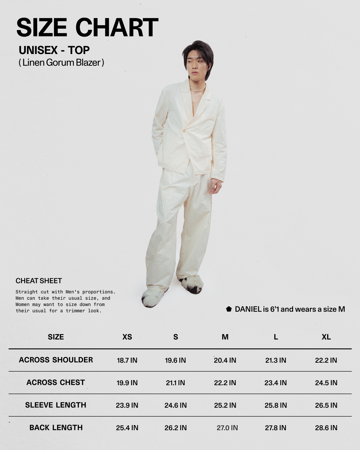 A person wearing the IVORY LINEN GORUM BLAZER and matching pants from Sundae School stands next to a size chart for this unisex linen blazer, which displays measurements for sizes XS to XL and notes that Daniel is 6'1" and wears a size M.