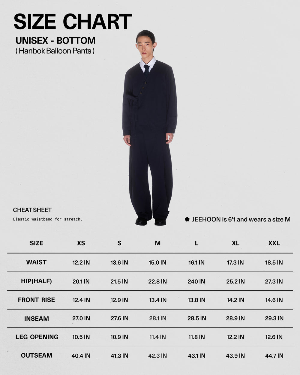 A model stands wearing Sundae School’s NAVY HANBOK BALLOON PANTS styled with a suit jacket. The size chart details unisex pant sizes XS–XXL, including waist, hip, front rise, inseam, leg opening, and outseam measurements in inches.