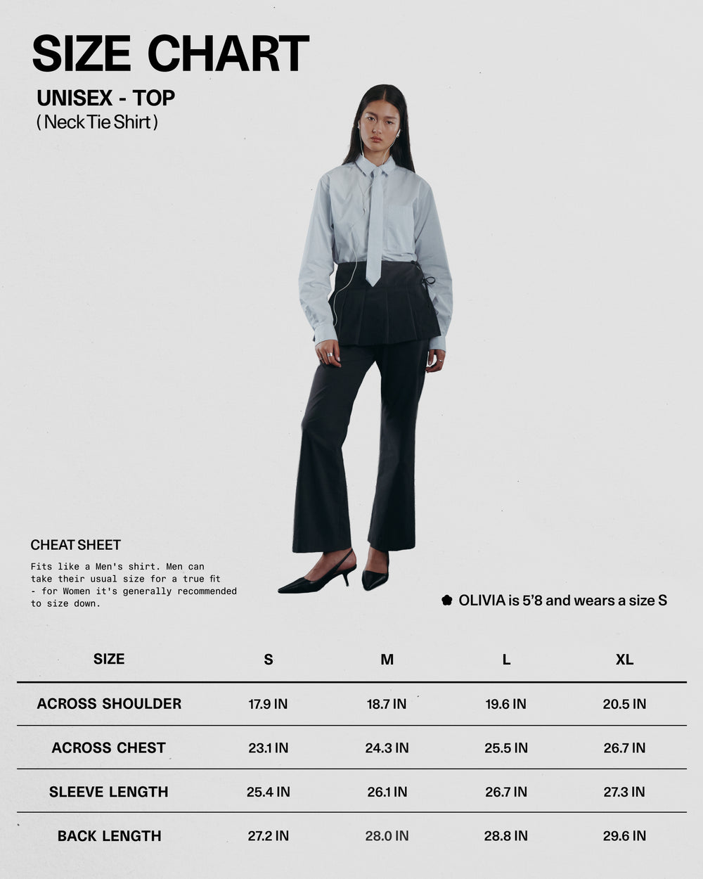 A woman in a relaxed Sundae School NECKTIE SHIRT with a removable tie and black pants stands by a size chart for the unisex NECKTIE SHIRT, showing measurements for sizes S to XL.