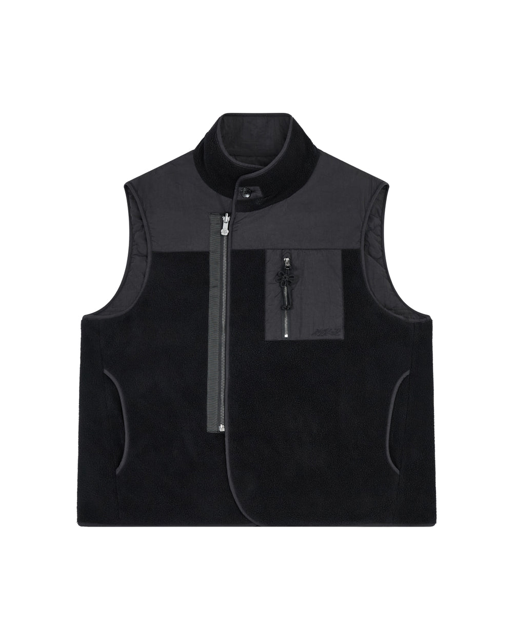 The BLACK MOMO REVERSIBLE FLEECE VEST by Sundae School is a sleeveless, black fleece vest featuring a high collar, asymmetrical front zipper, zippered chest pocket, and side pockets. The vest is displayed flat on a white background.