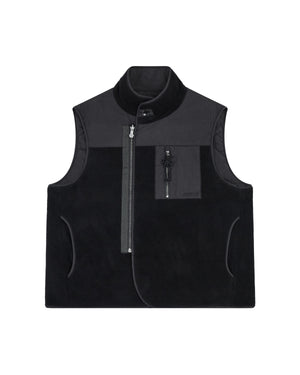 The BLACK MOMO REVERSIBLE FLEECE VEST by Sundae School is a sleeveless, black fleece vest featuring a high collar, asymmetrical front zipper, zippered chest pocket, and side pockets. The vest is displayed flat on a white background.