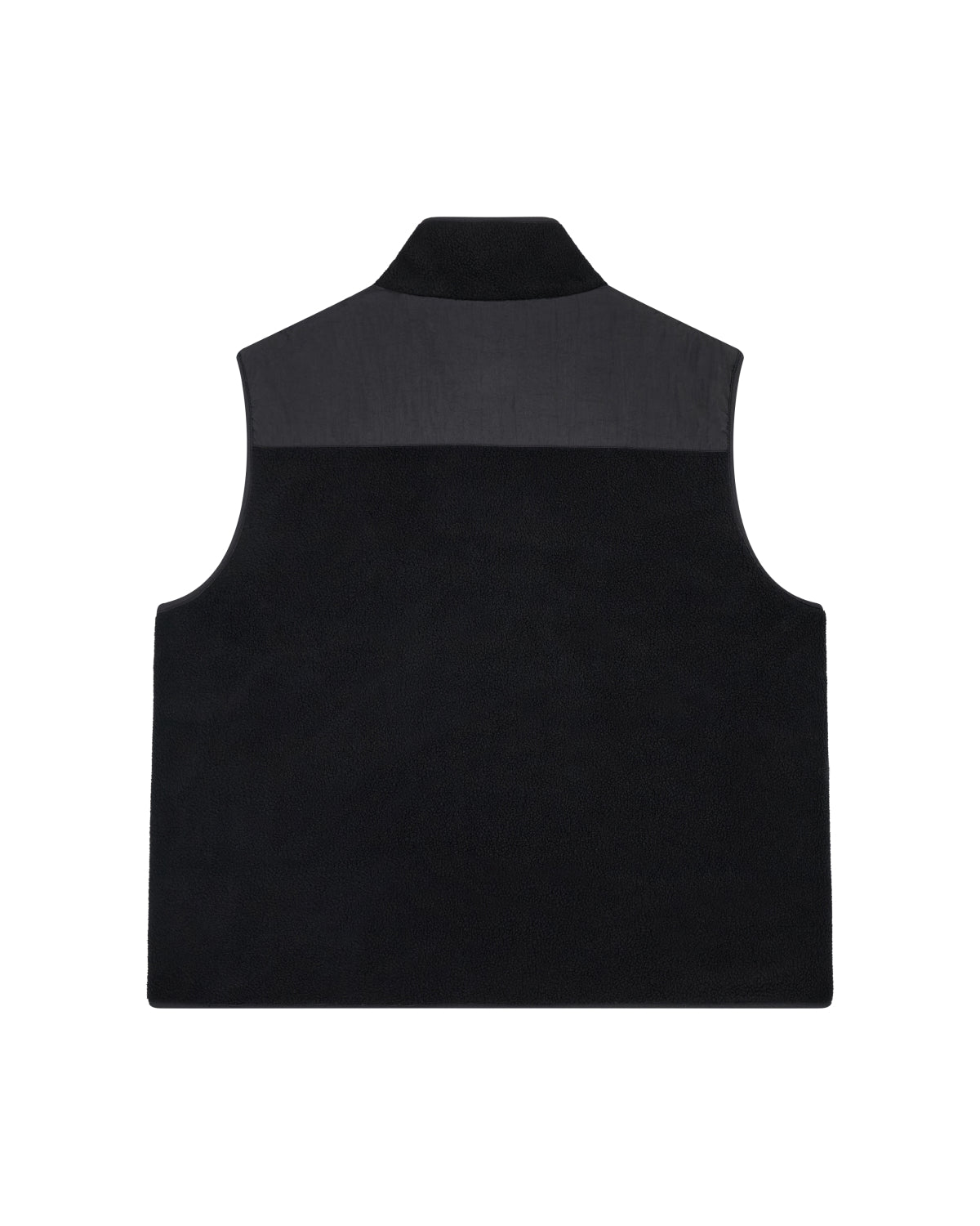 The BLACK MOMO REVERSIBLE FLEECE VEST by Sundae School is a black, sleeveless vest with a high collar and a contrasting darker panel across the shoulders. It is displayed flat, photographed from the back against a white background.