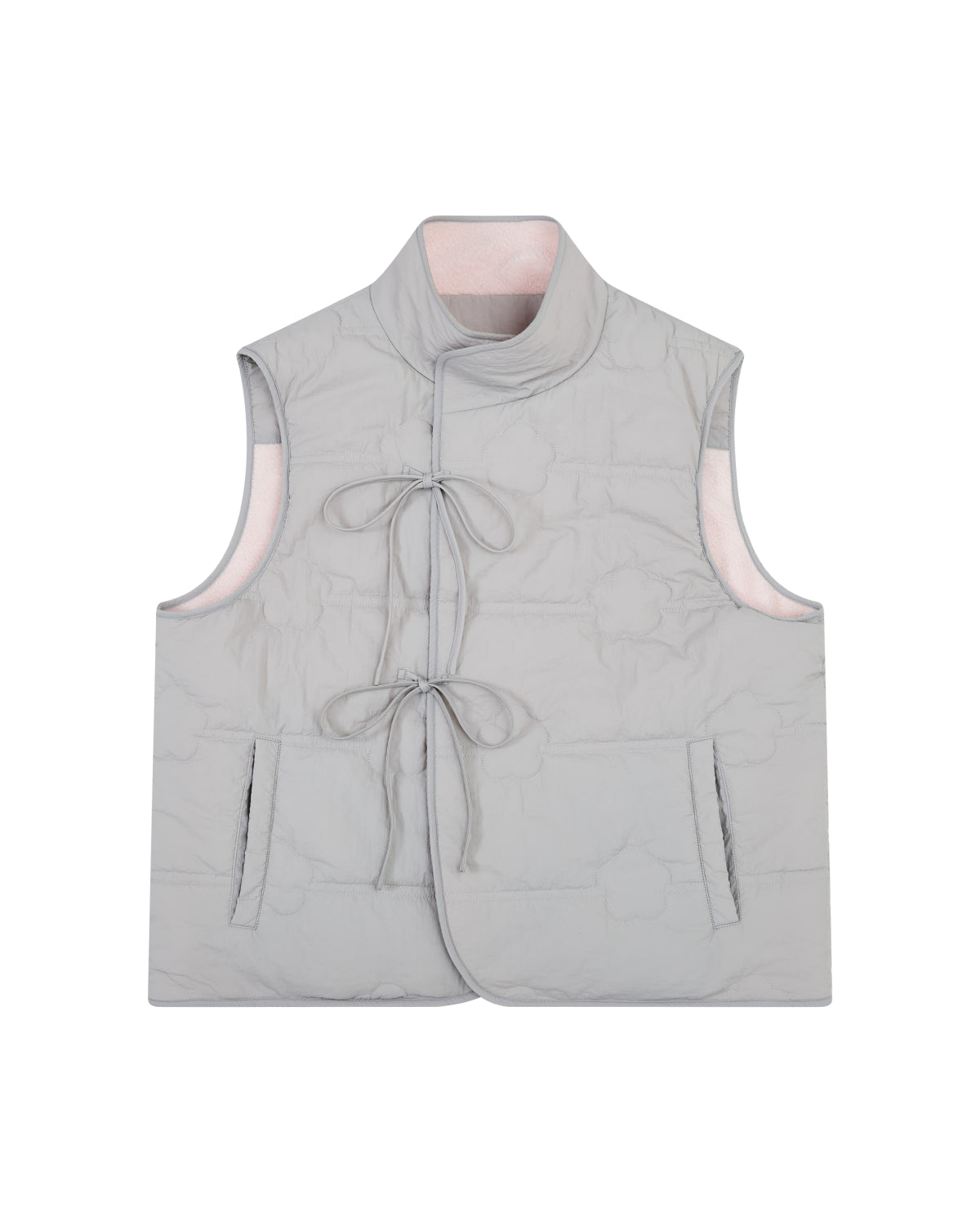 The BABY PINK MOMO REVERSIBLE FLEECE VEST by Sundae School features a light gray, sleeveless quilted exterior with two front pockets, a mandarin collar, and two front ties for closure. The vest is reversible, revealing a soft light pink interior lining.