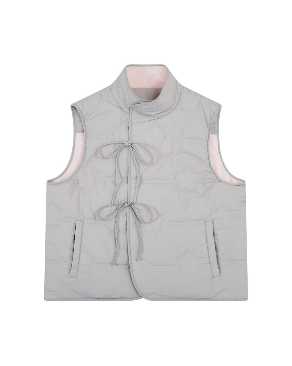 The BABY PINK MOMO REVERSIBLE FLEECE VEST by Sundae School features a light gray, sleeveless quilted exterior with two front pockets, a mandarin collar, and two front ties for closure. The vest is reversible, revealing a soft light pink interior lining.
