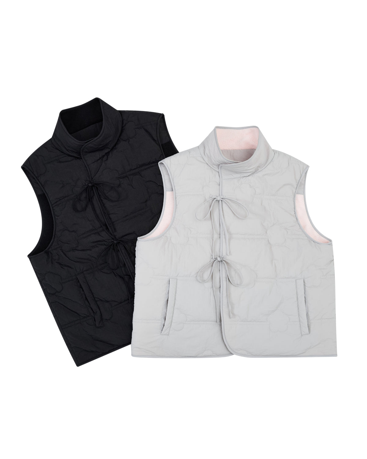 The BLACK MOMO REVERSIBLE FLEECE VEST by Sundae School is shown in both black and light gray, displayed side by side on a white background. Each sleeveless quilted vest features front pockets and tied bow closures down the center.