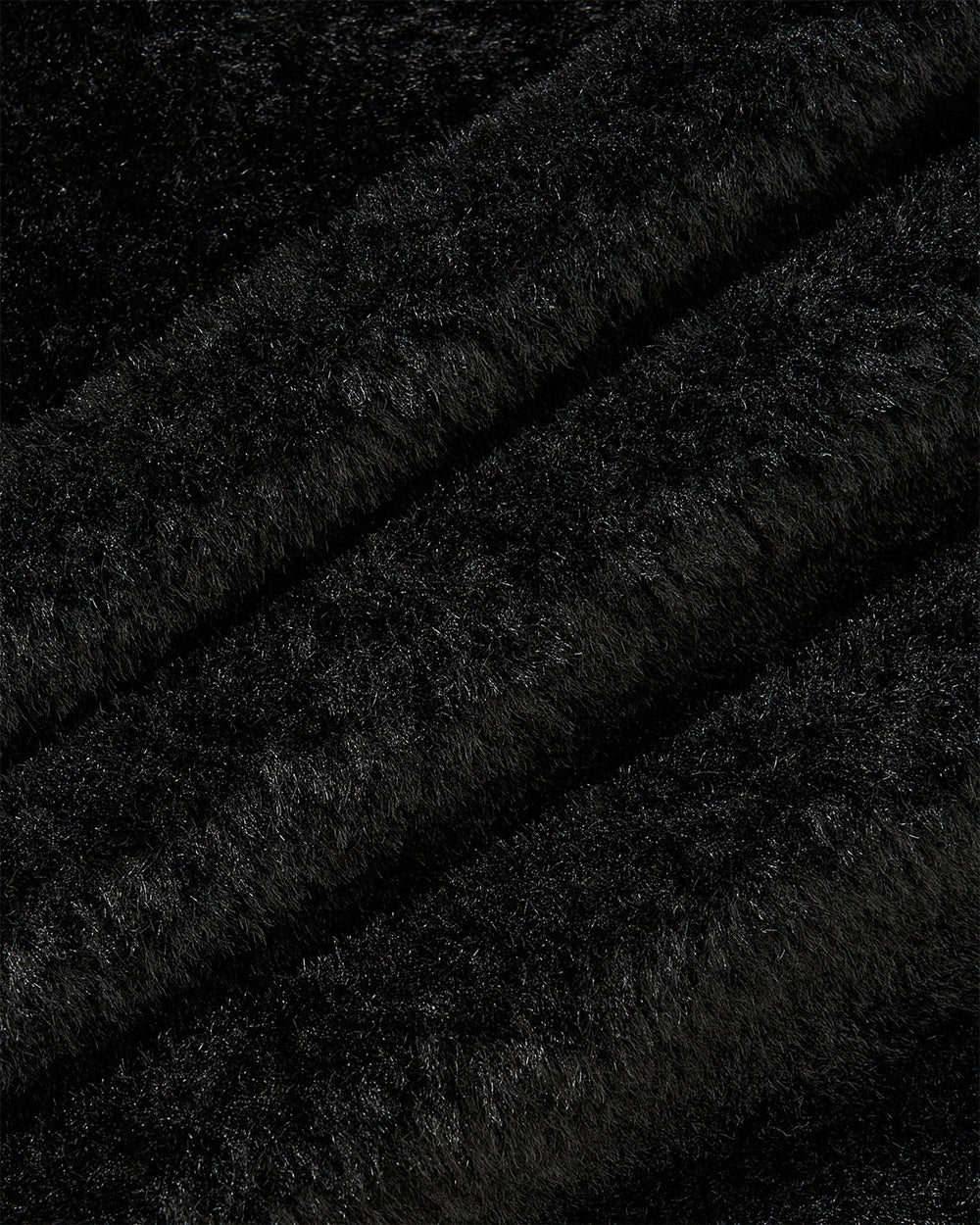 Close-up of Sundae School’s MUGUNGHWA FLEECE in black, showcasing its soft and fluffy fabric with a dense, sherpa-like texture and gentle, wavy diagonal lines throughout.