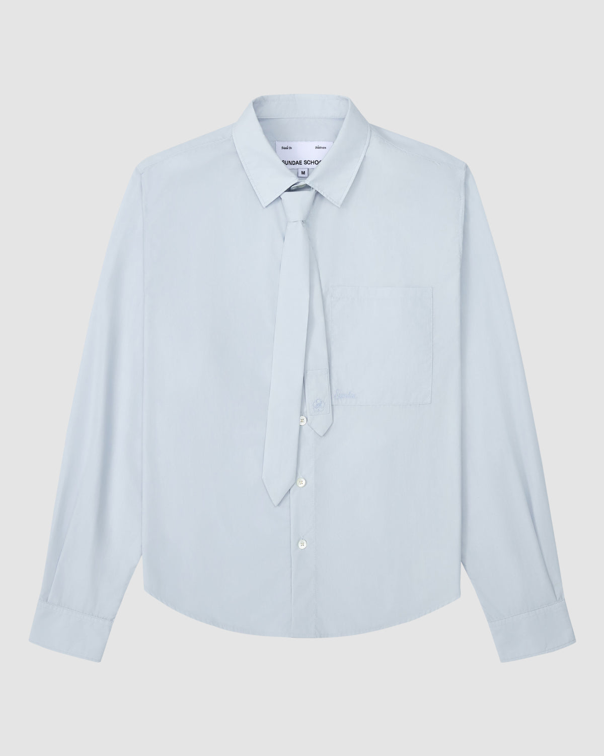 The NECKTIE SHIRT by Sundae School is a light blue, relaxed-fit long-sleeve shirt with a single stash pocket and a removable matching tie, displayed flat on a white background.