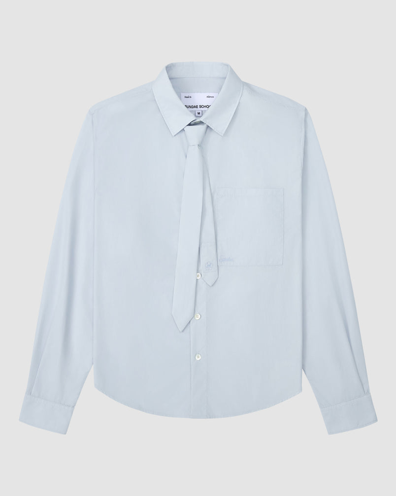 The NECKTIE SHIRT by Sundae School is a light blue, relaxed-fit long-sleeve shirt with a single stash pocket and a removable matching tie, displayed flat on a white background.