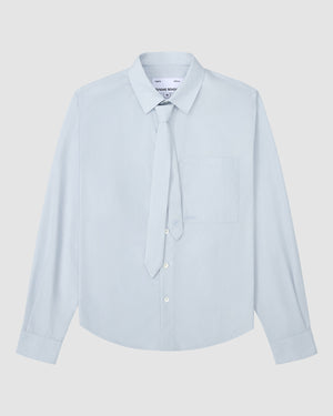 The NECKTIE SHIRT by Sundae School is a light blue, relaxed-fit long-sleeve shirt with a single stash pocket and a removable matching tie, displayed flat on a white background.