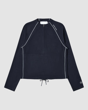 The NAVY OFFICE QUARTER ZIP by Sundae School is a navy cotton jersey long-sleeve pullover featuring white piping, a quarter-zip front, drawstring hem, stash pocket, and subtle white logos on the collar and sleeve. Displayed flat on light gray.