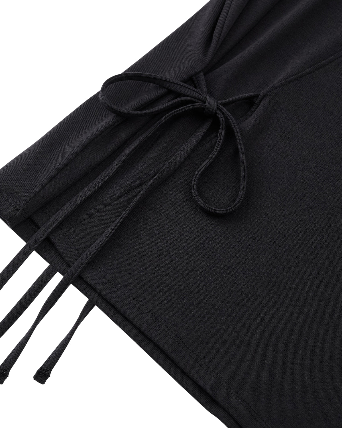 Close-up of the BLACK ORIGAMI GORUM TEE by Sundae School, showcasing a side tie detail with thin, matching black strings, neatly bow-tied, against a white background.